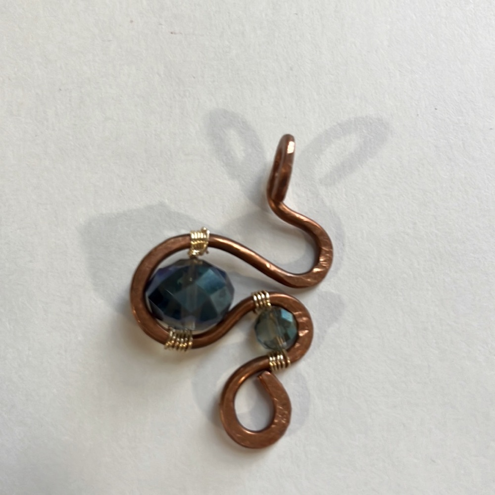 A handmade copper pendant